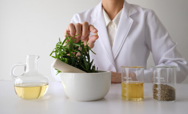 Evidence based medicine, complementary and alternative medicine. Making herbal medicine in lab with herb leaves vitamin supplements mineral complementary and alternative medicine research.